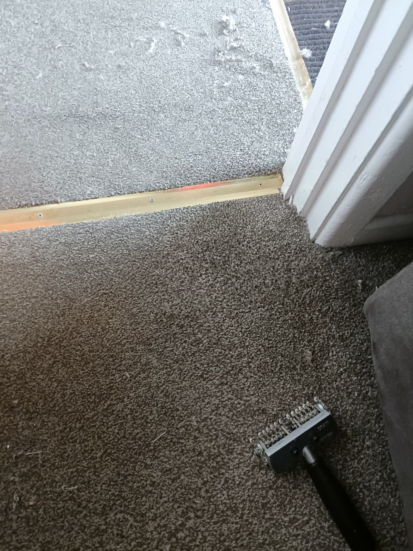 Carpet repair by a doorway threshold in Rotherham, after professional cleaning