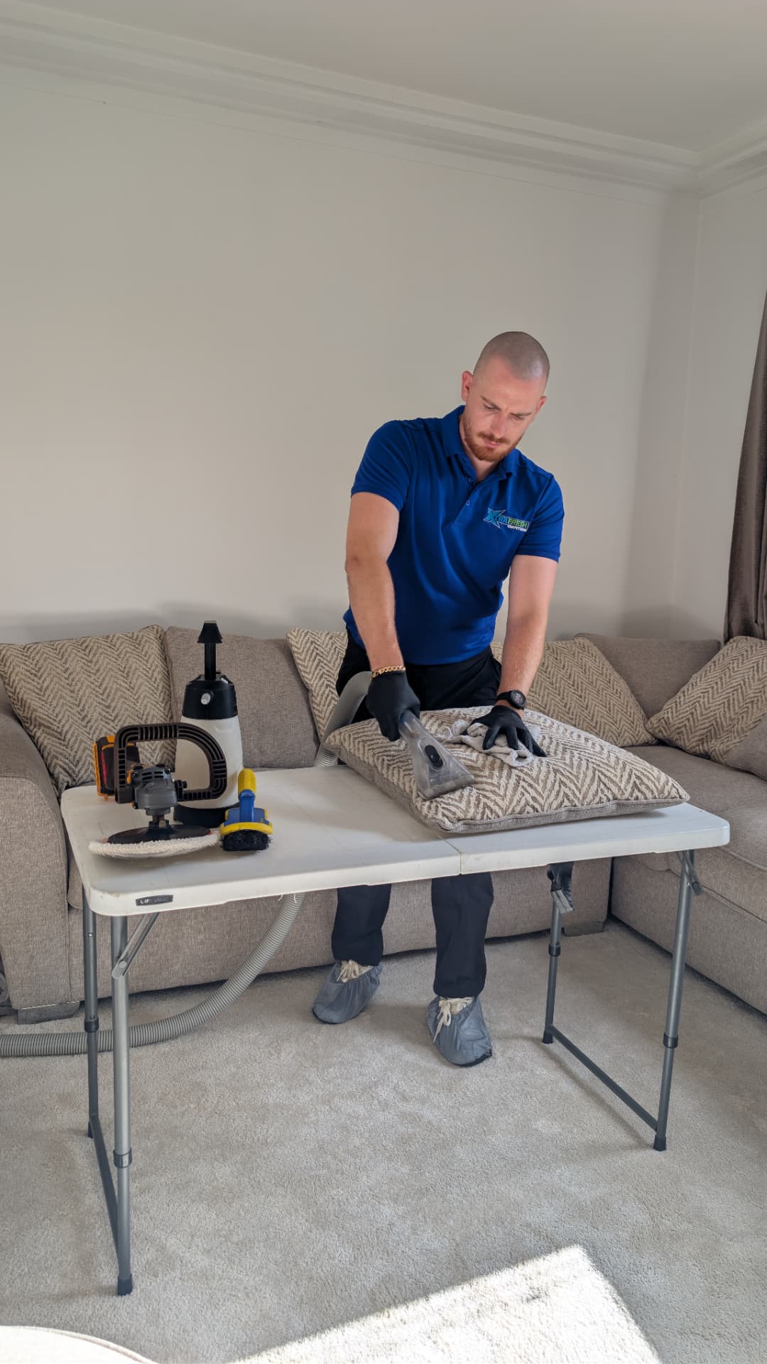 XtraFresh technician cleaning upholstery at a work table in Rotherham