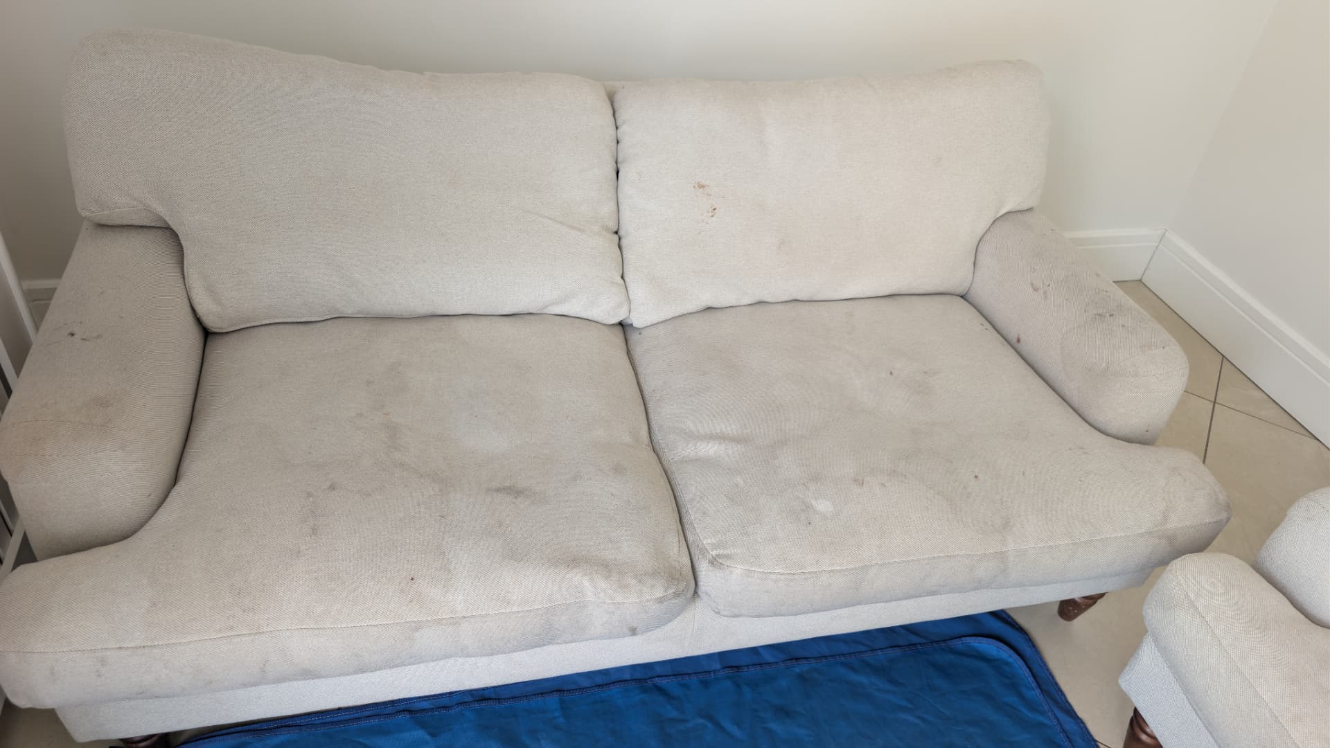 White fabric sofa cleaned in Rotherham, before professional cleaning